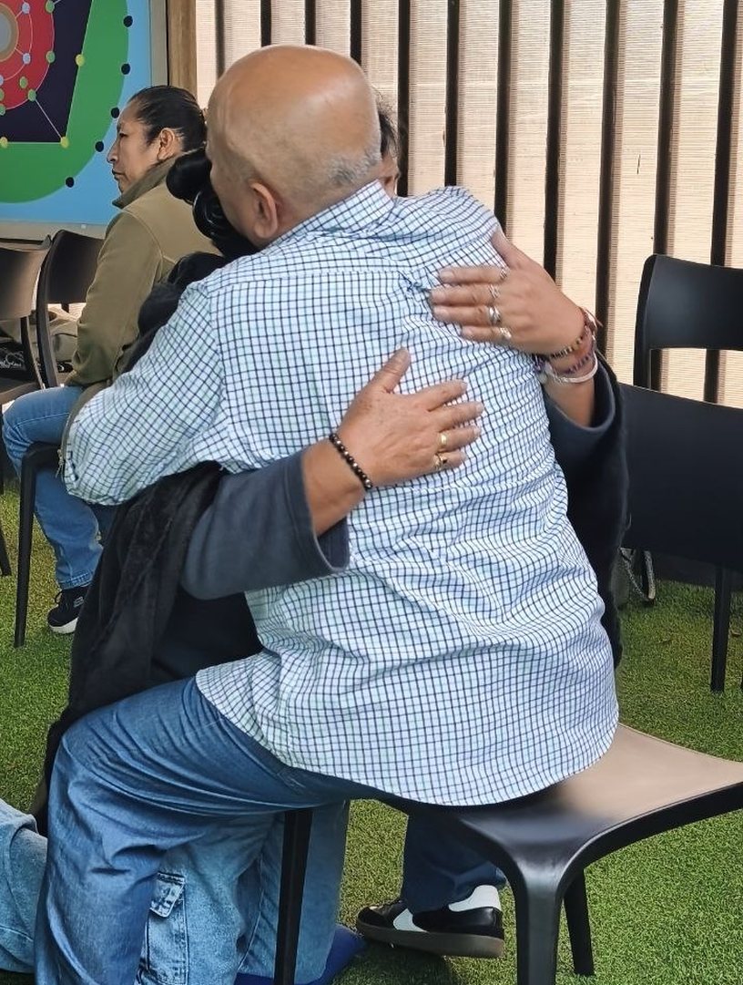 Dos participantes abrazándose durante un ejercicio vivencial de El Pacto del Alma